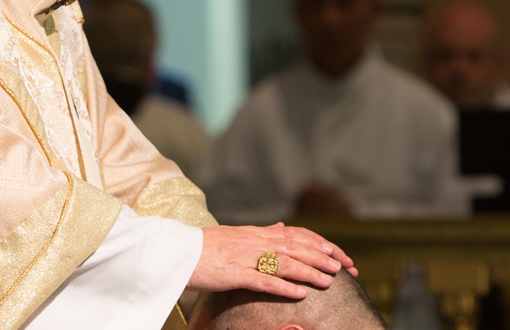 Picture shows the Ordaining Bishop laying his hands on the candidate to be ordained a deacon