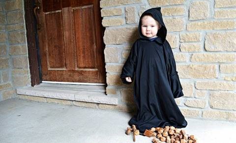 A young child dressed as a monk