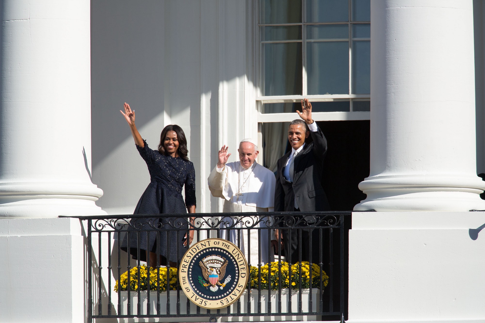 Pope Francis Waves from a White House Balcony with Barack and Michelle Obama, then-the first family of the United States, during his 2015 trip to the United States