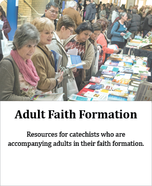 2018 conference attendees standing at Novalis booth looking at books for their formation