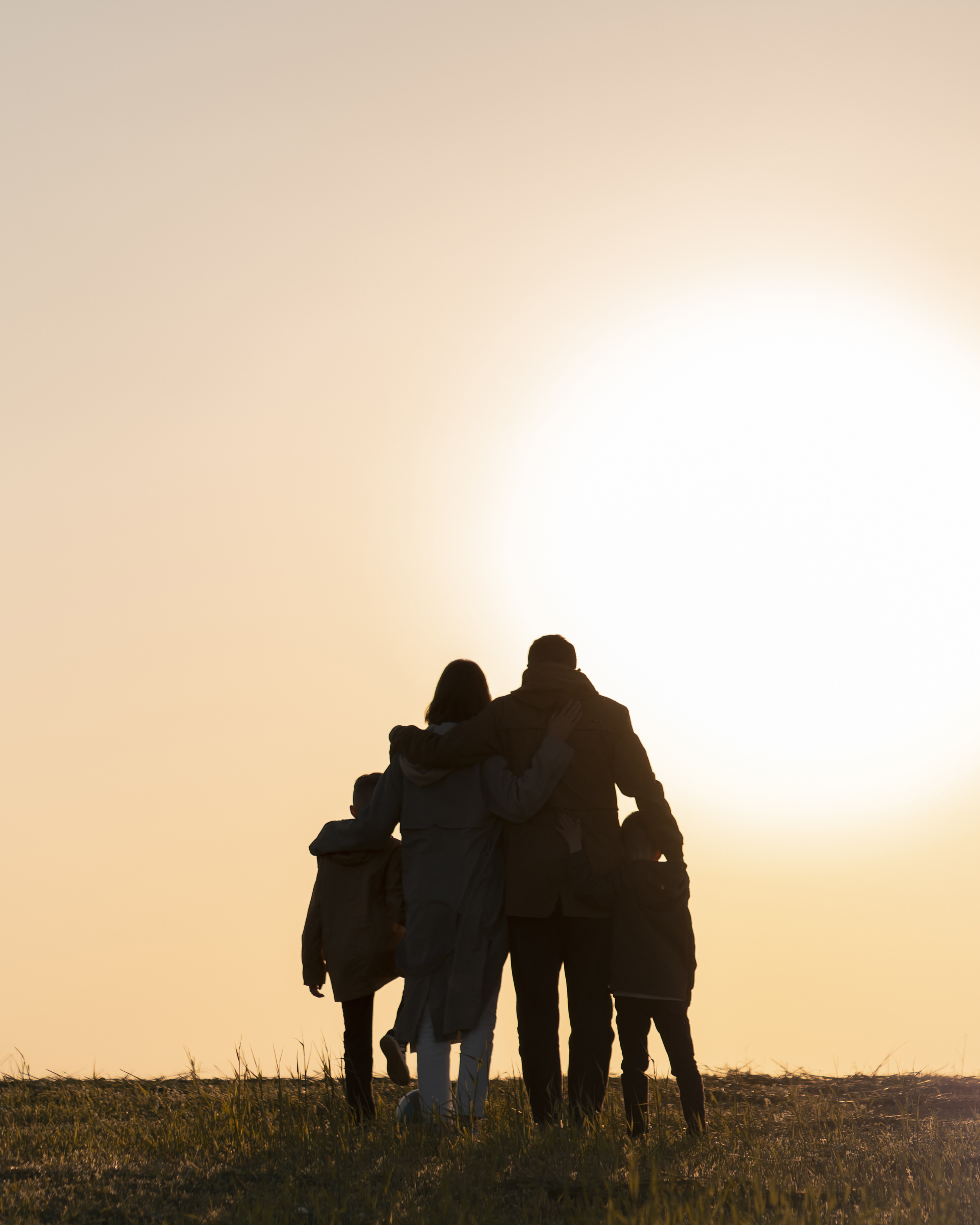 Family silhouette having fun at sunset