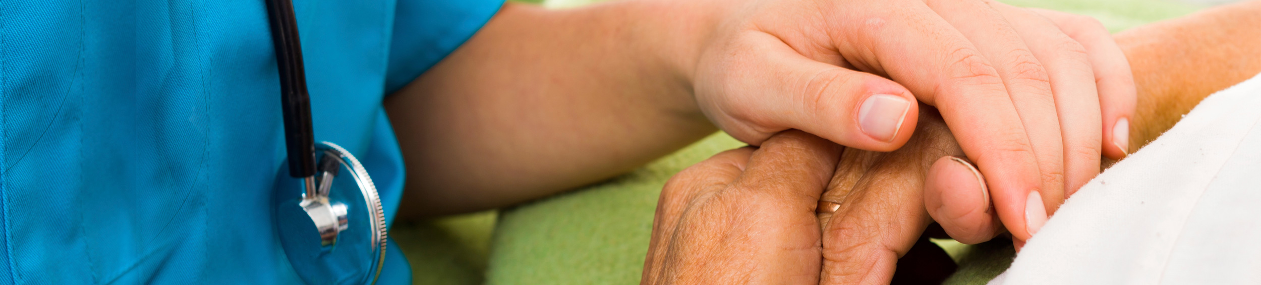 Hands of health care worker and patient