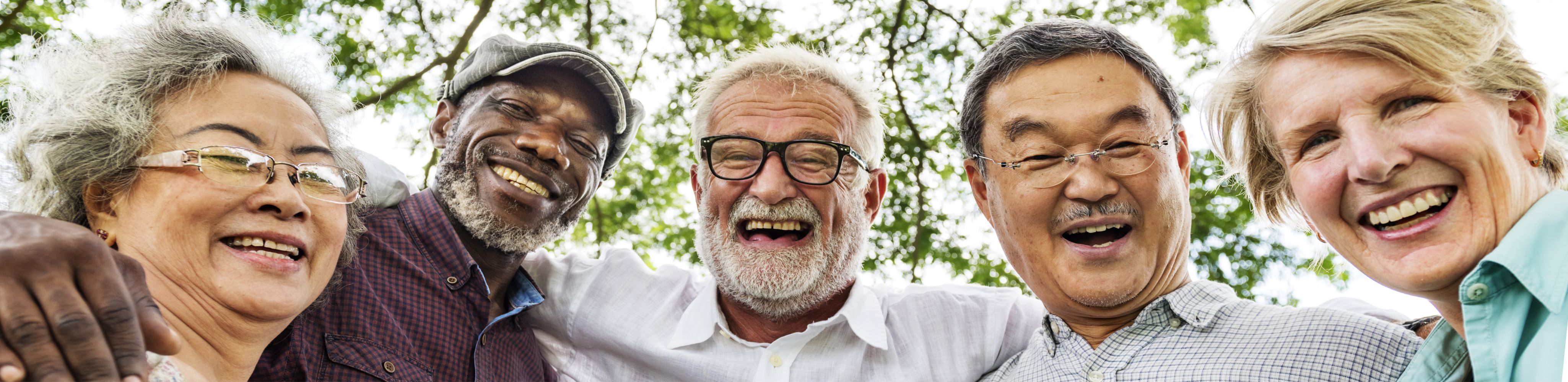 group of older men and woman arm-in-arm smiling